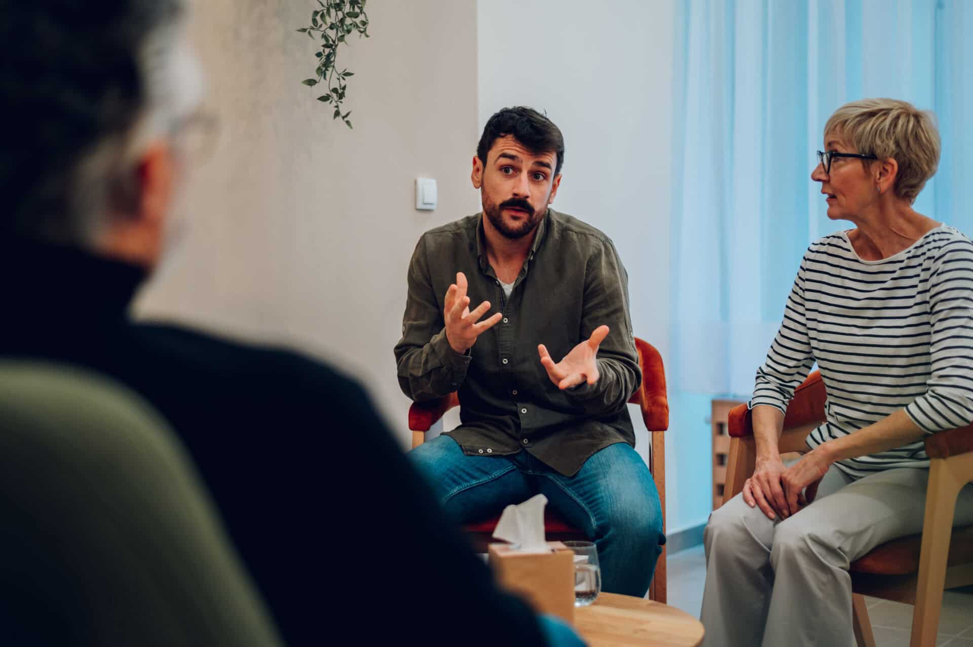 Young man talking about his mental health on a group therapy session at cocaine rehab in Marlton NJ