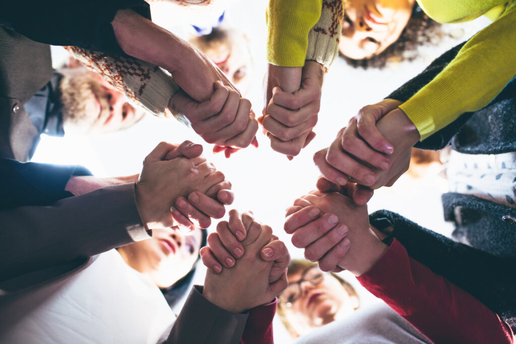 group of individuals supporting each other by holding hands at Full of Life Recovery Center's php program in Marlton, NJ