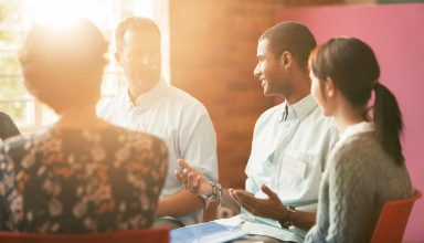 Man talking in group therapy session about Recognizing the Signs of Heroin Abuse